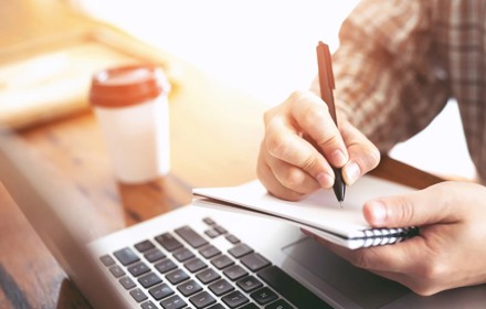 A Person Studying With Notepad