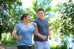 Young couple exercising outside. 