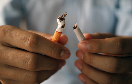 Person Breaking Cigarette