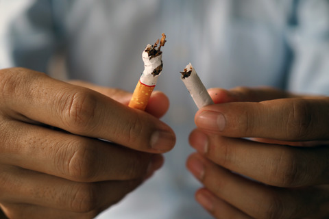Person Breaking Cigarette