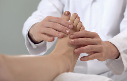 Doctor Inspecting Foot