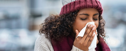 Woman With Cold Sneezing Outdoor