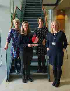 A group of DRWF funded researchers holding our research funding award.  