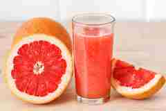 Grapefruit juice and a glass. 