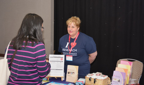 Debra At Booth With Attendee Wellness Day 22