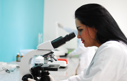 Researcher Using A Microscope In Lab R