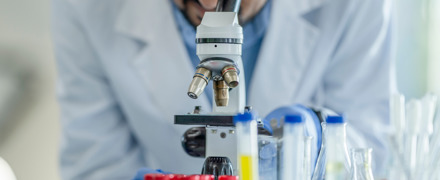 Medical Researcher Looking Through Telescope