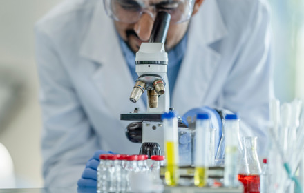 Medical Researcher Looking Through Telescope