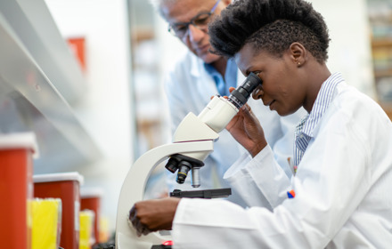 Medical Researcher Using Microscope
