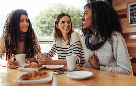 Friends Talking In Cafe