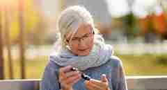 An elderly woman checking her blood sugar levels. 