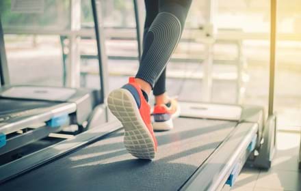 Woman Running On A Treadmill.