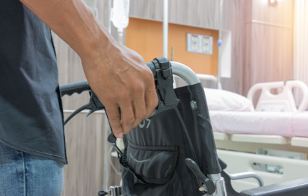 Man Holding Wheelchair
