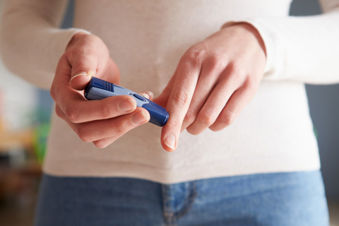 A Person Performing Finger Prick Test