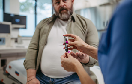 Man Holding A Glucose Monitoring Pen