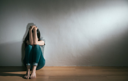 A Stressed Person With Hands Covering Face