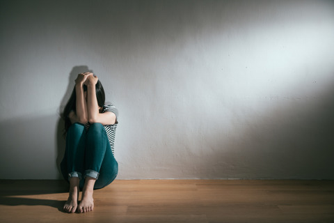 A Stressed Person With Hands Covering Face