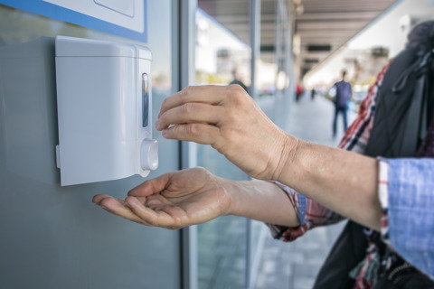 Woman Using Hand Sanitizer