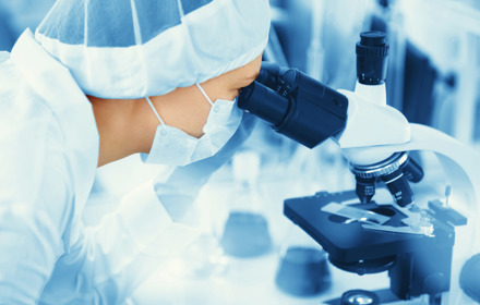 Researcher Looking Through Microscope