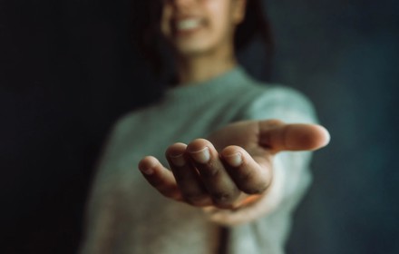 Woman Offering Hand To Camera