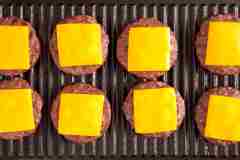 Cheeseburgers on a grill. 