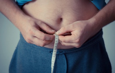 Person Holding Measuring Tape Around His Body