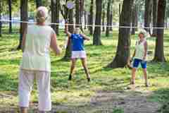 Older people playing badminton. 