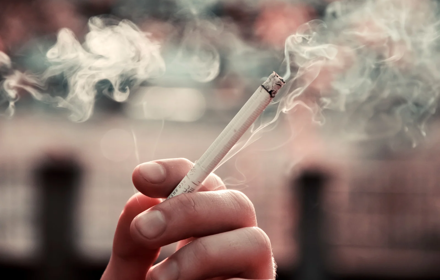 A Person Holding A Cigarette